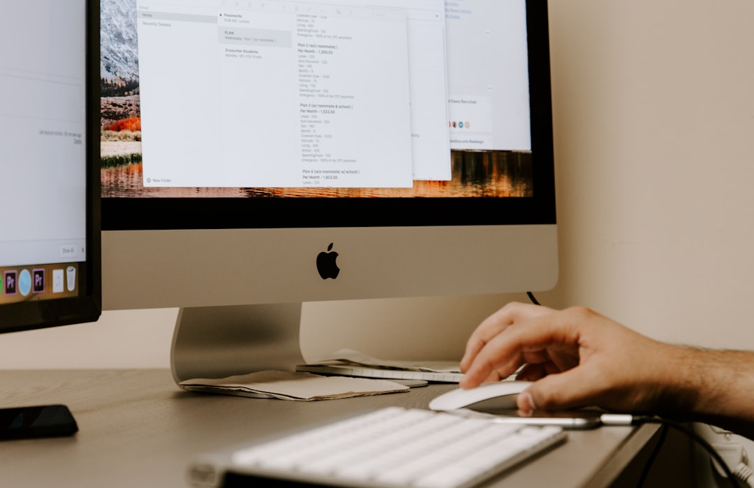 person-holding-white-apple-magic-mouse-beside-imac-and-keyboard-6ywknenldki